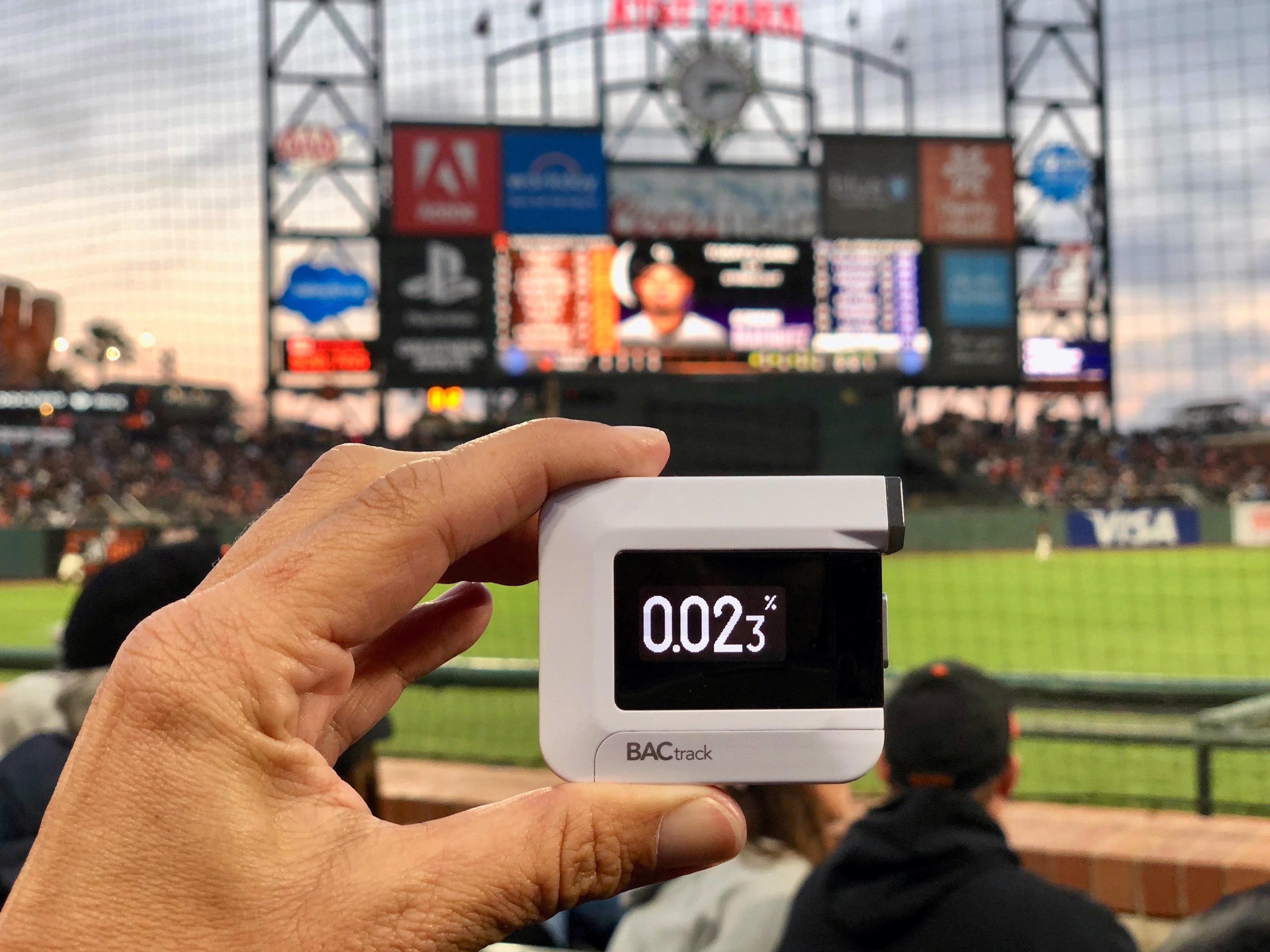 Man with BACtrack C6 breathalyzer at baseball game