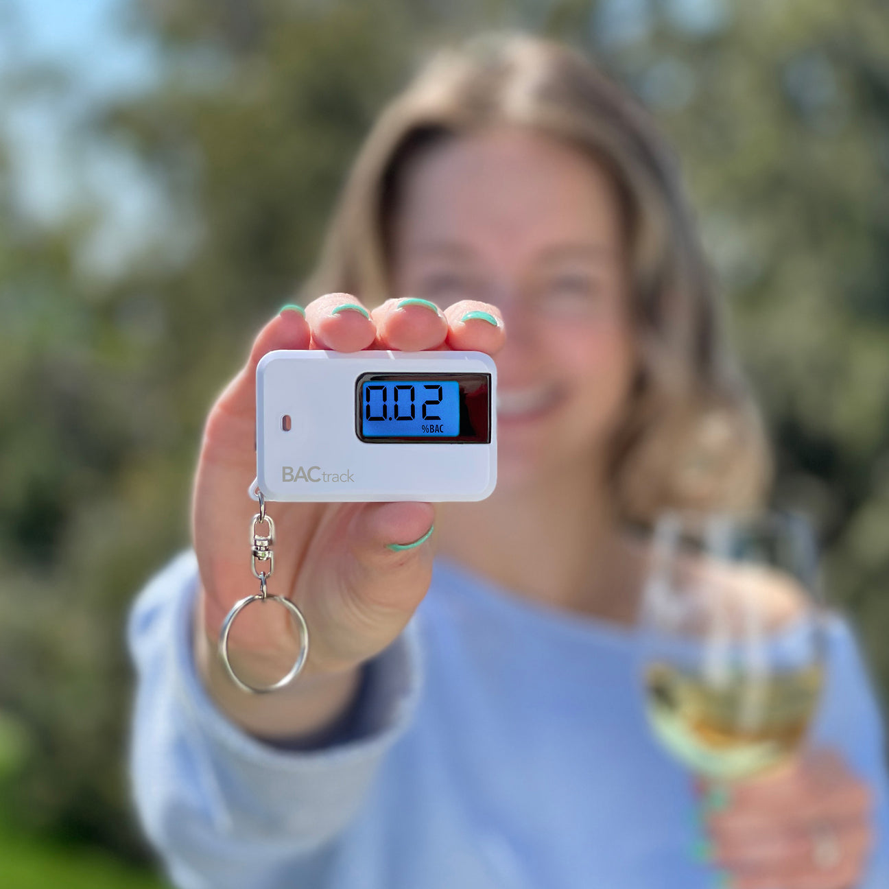 Woman with BACtrack Go breathalyzer