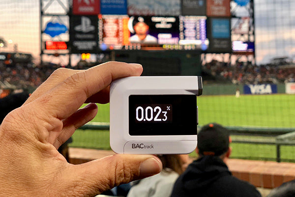 Man with BACtrack C6 breathalyzer at baseball game